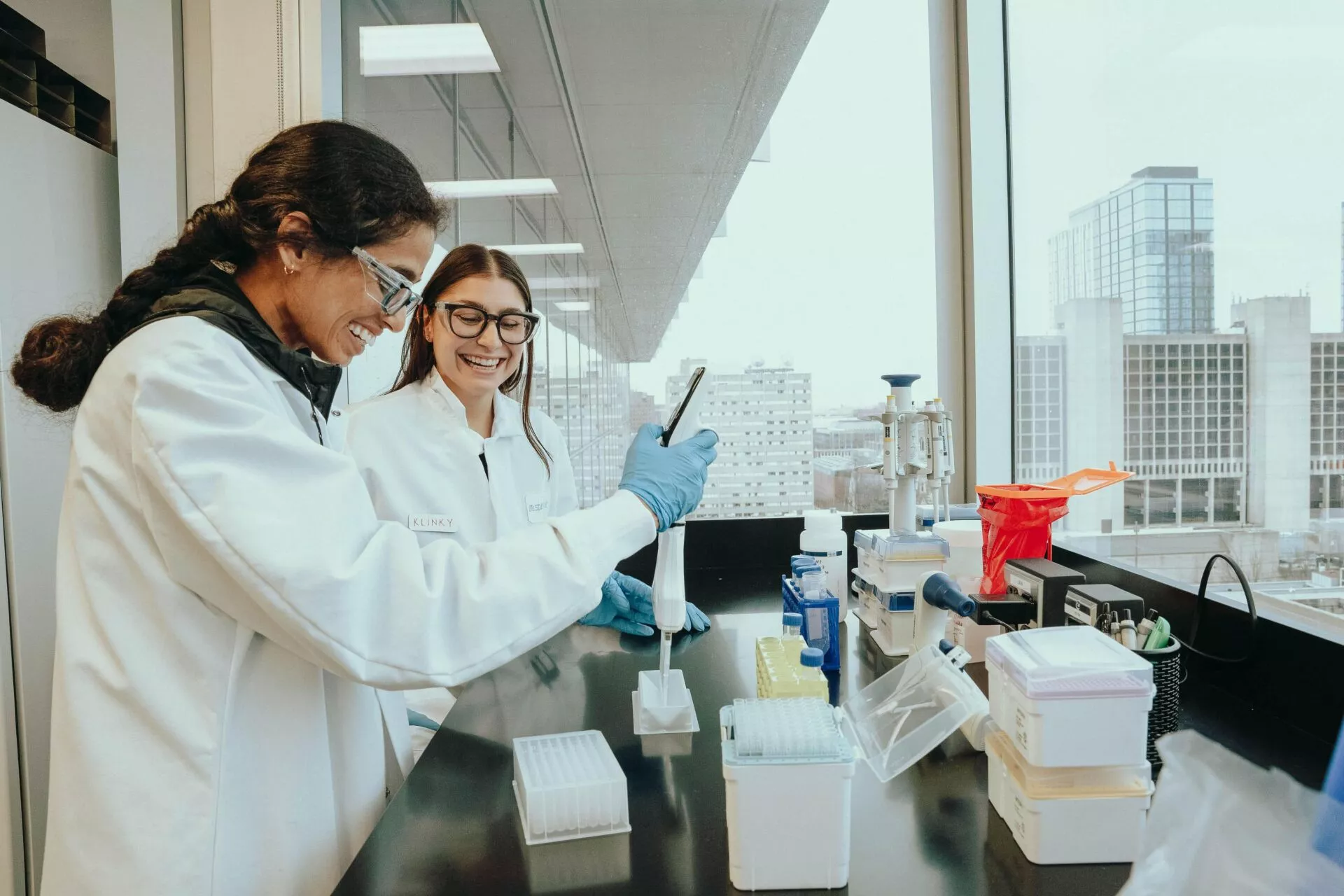 Spirovant scientists preparing samples for analysis, with expansive views of University City. Photo credit: Jay Williams, Jay’s Entertainment LLC